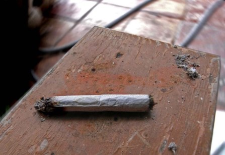 A hand rolled cigarette on a table